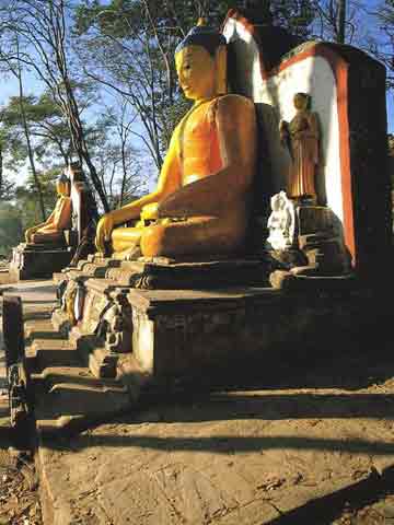 
Stone Buddhas flank the stairs at the foot of the steps to Swayambhunath - Nepal: The Mountains Of Heaven book
